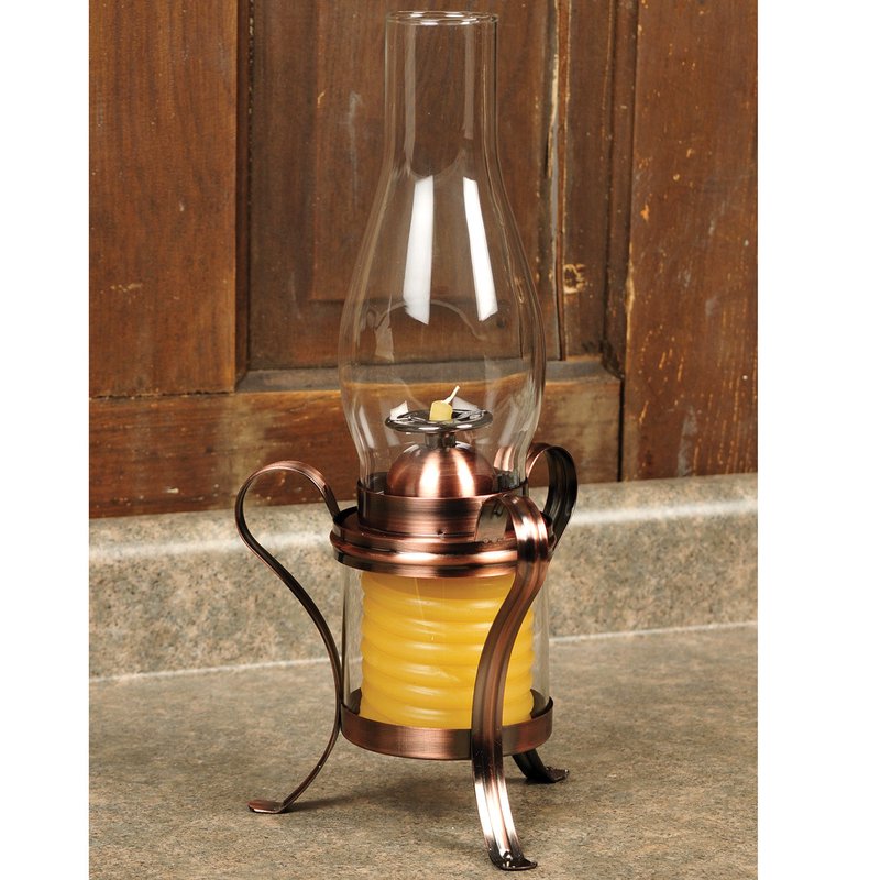 Handcrafted hurricane candle lamp with a copper-finished metal frame and a beeswax coil, featuring a clear glass chimney for safe, adjustable lighting in lamps and candles collections.
