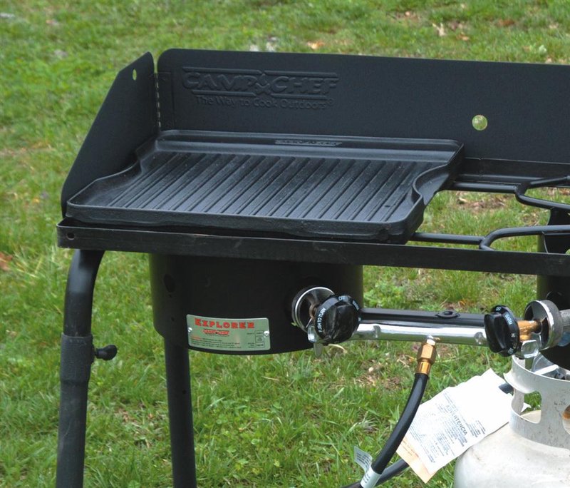 Small cast iron grill/griddle with ridged surface set on a portable propane burner, suited for outdoor cooking in Kitchen & Food, Cast Iron, Cookware, and Stoves collections.