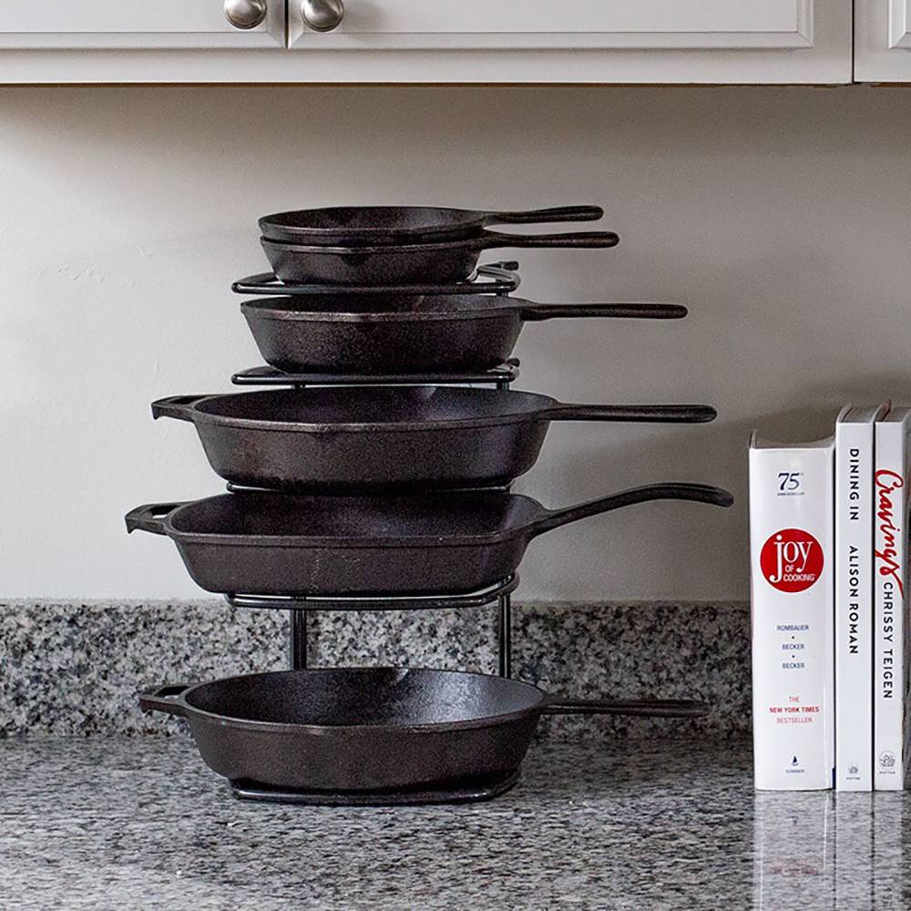 Five-tier black steel cookware organizer holding various sizes of cast iron skillets, designed for kitchen countertops or cabinets, featured in Kitchen & Food, Kitchen Gadgets, Kitchen Accessories, Storage and Serving, Best Sellers, Promo Eligible collections.