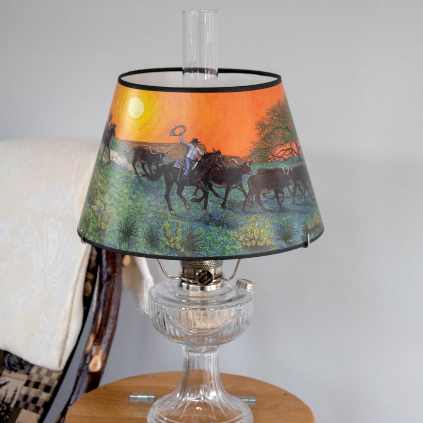 Handcrafted parchment lamp shade with Southwestern artwork of a cowboy herding cattle through bluebonnet fields at sunset, designed to soften light for Aladdin oil lamps in Lamps & Lighting, Parts and Accessories, Lamp Shades, and Best Sellers collections.