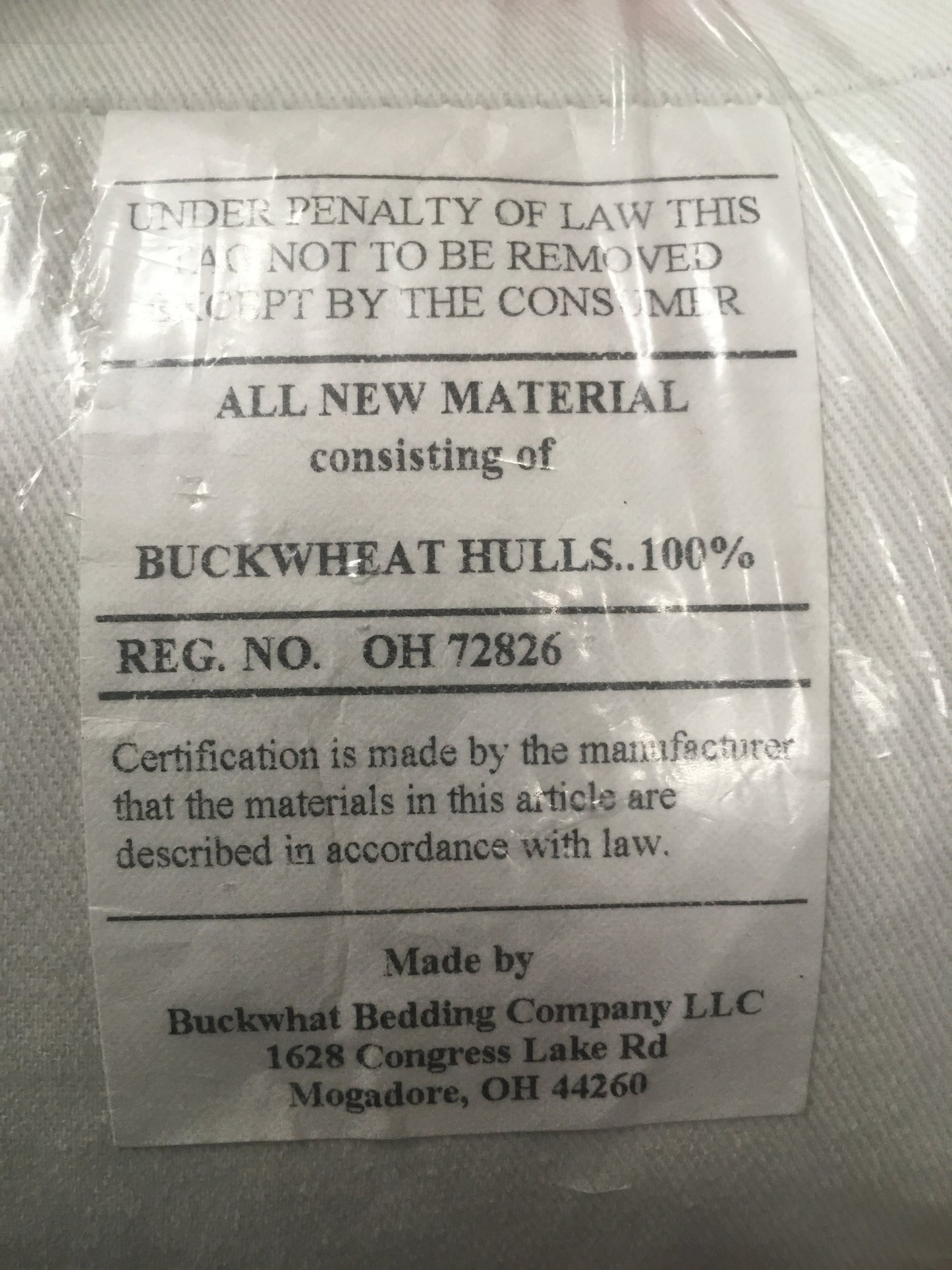Close-up of a certification label on a handcrafted pillow cover, confirming 100% natural buckwheat hull filling, made in the USA, part of Home & Decor, Home Textiles, USA Made, and Best Sellers collections.