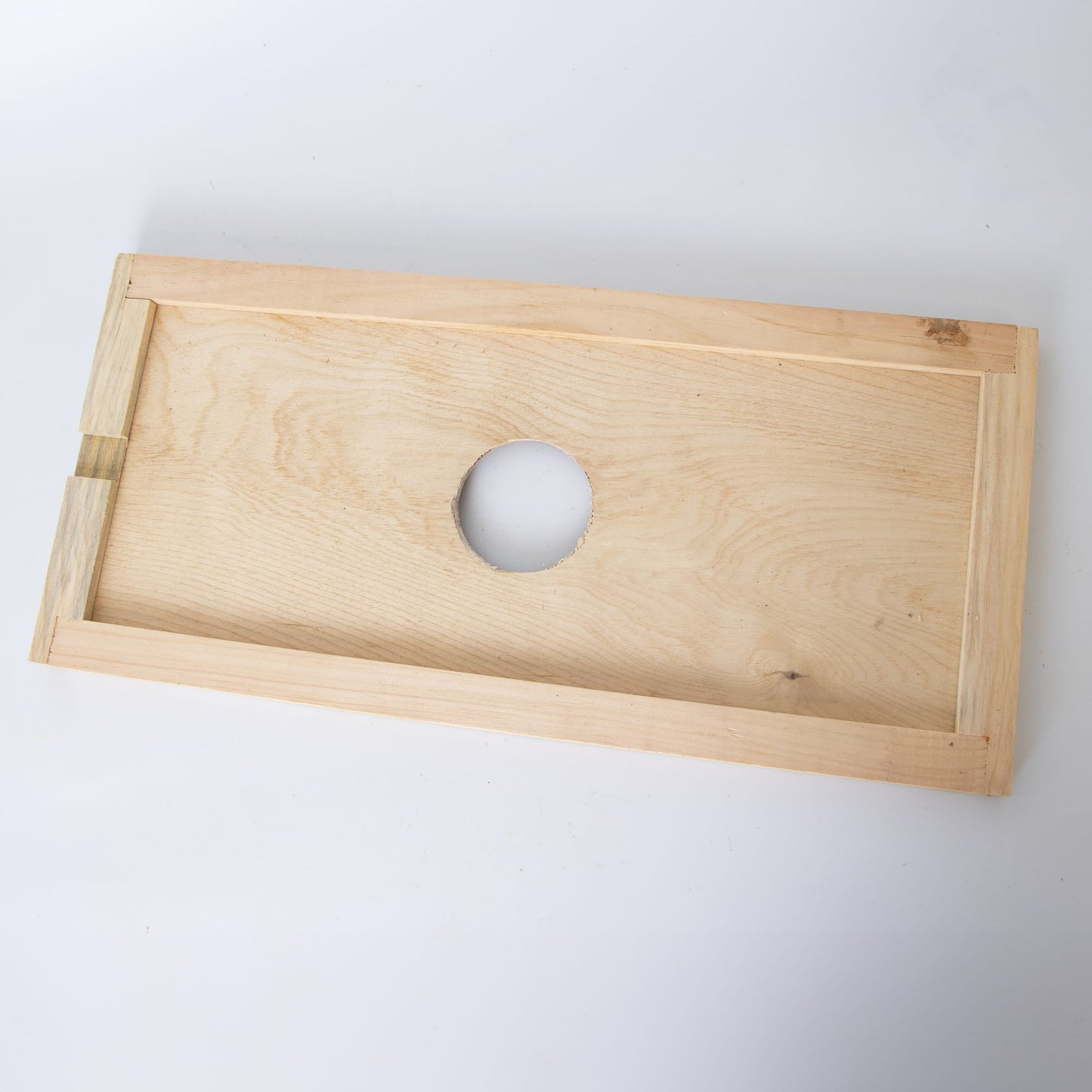 Handmade Amish crafted wooden hive inner cover with a 2-3/4 inch center ventilation hole, designed for moisture control and airflow, part of USA made beekeeping supplies.