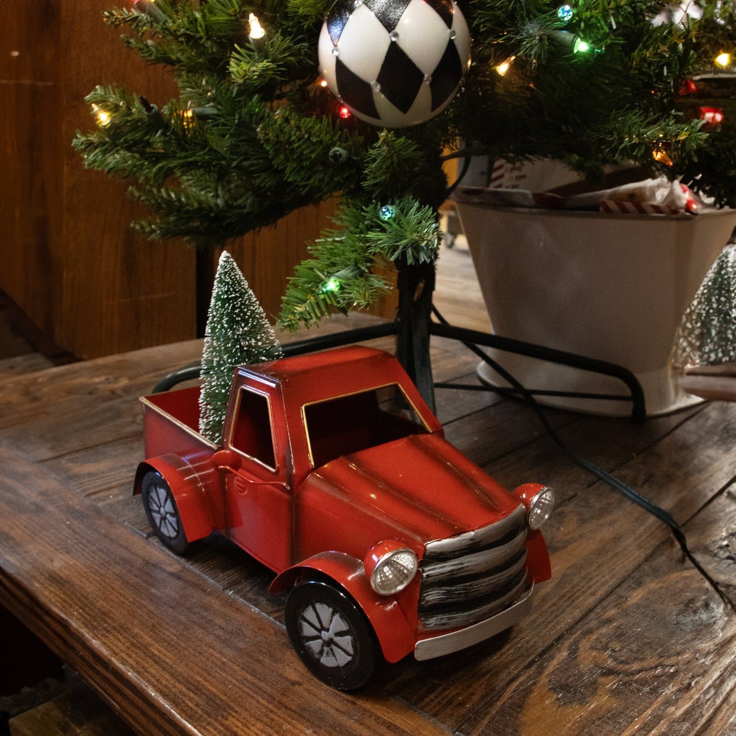 Handcrafted red metal vintage-style holiday truck with a lighted miniature green tree in its bed, perfect for Home & Decor, Holiday Decor, Best Sellers, and Promo Eligible collections.