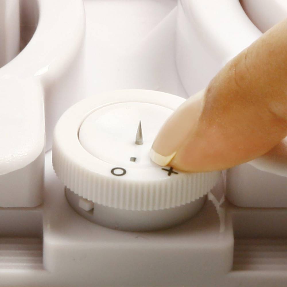 Close-up of a finger adjusting the built-in egg piercer on a white 4-in-1 hard-boiled egg slicer, designed for precise food prep in Kitchen & Food and Kitchen Gadgets collections.
