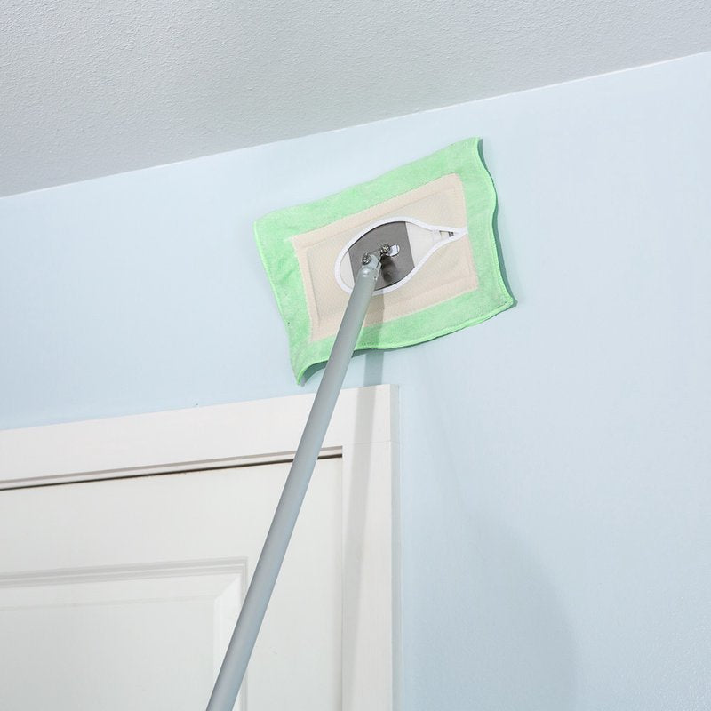 Light green microfiber replacement mop head attached to a long handle, gently cleaning a high wall surface; handcrafted and Amish made, ideal for household cleaning and home decor.