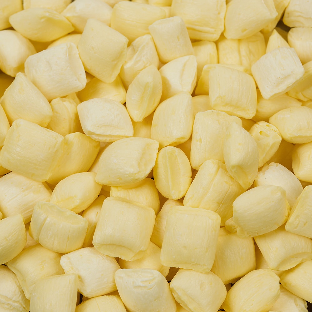 Close-up of pale yellow buttermint candies with a smooth, rich texture and buttery mint flavor, handcrafted in the USA, featured in Kitchen & Food, Snacks and Sweets, Candy, USA Made, and Best Sellers collections.