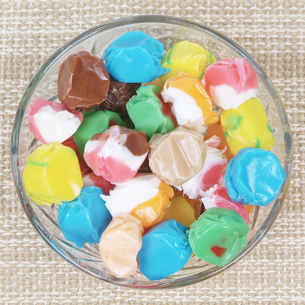 Glass bowl filled with vibrant, assorted hand-dipped taffy candies in various colors, showcasing a handcrafted sweet treat from Kitchen & Food, Snacks and Sweets, Best Sellers, and Promo Eligible collections.