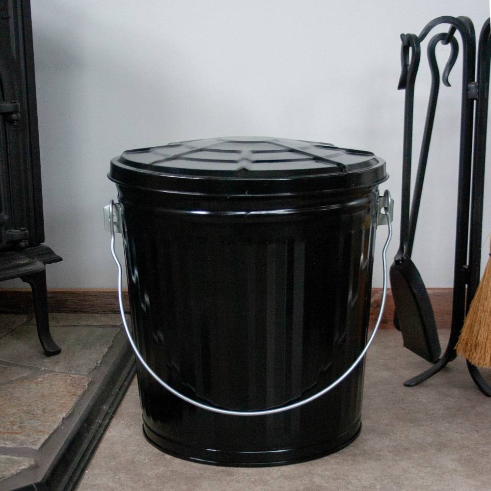 Black painted steel ash pail with a secure lid and strong metal bail handle, handcrafted for long-lasting use in Stoves, Hearth Accessories, Best Sellers, and Promo Eligible collections.