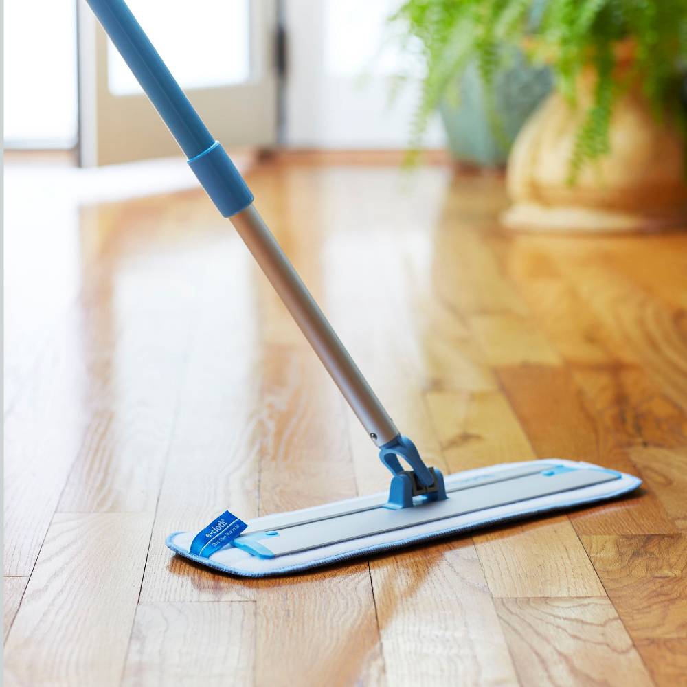 Telescoping handle mop with plush cleaning pad gliding over a polished hardwood floor, ideal for household cleaning and best sellers in Home & Decor and Cleaning Utensils collections.