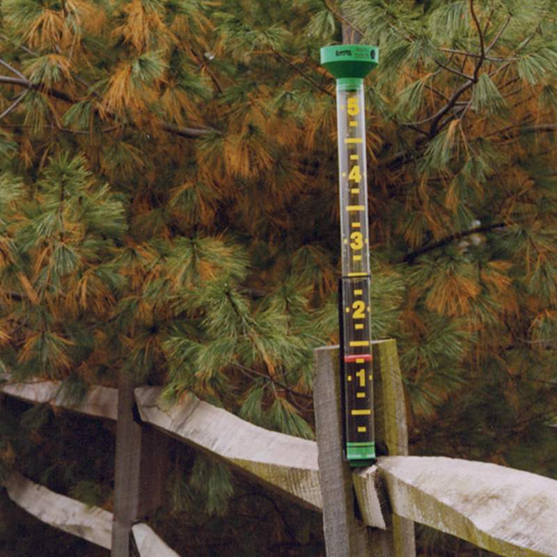 Tall rain gauge with bright red float and clear yellow markings up to 5 inches, made of UV-stabilized plastic, visible from 50 feet, suitable for garden and farm use, USA made