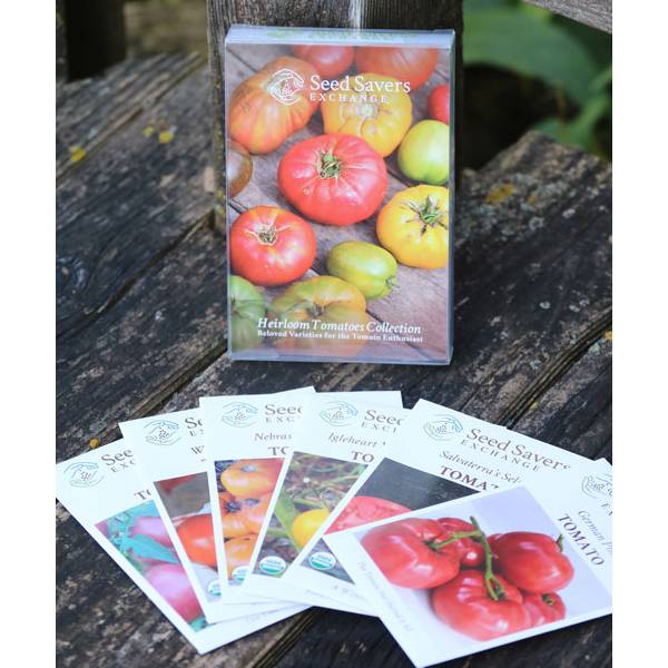 Seed Savers Exchange heirloom tomato seed packets featuring six unique varieties displayed fanned out on a wooden surface, highlighting Farm, Garden & Tool and USA Made qualities.