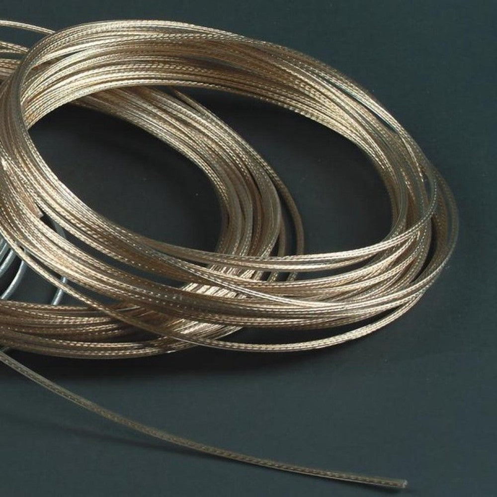 Coiled 12-strand brass-plated cable for durable clothesline use, handcrafted for reliable, snag-free laundry and featured in Home & Decor and Laundry Supplies collections.