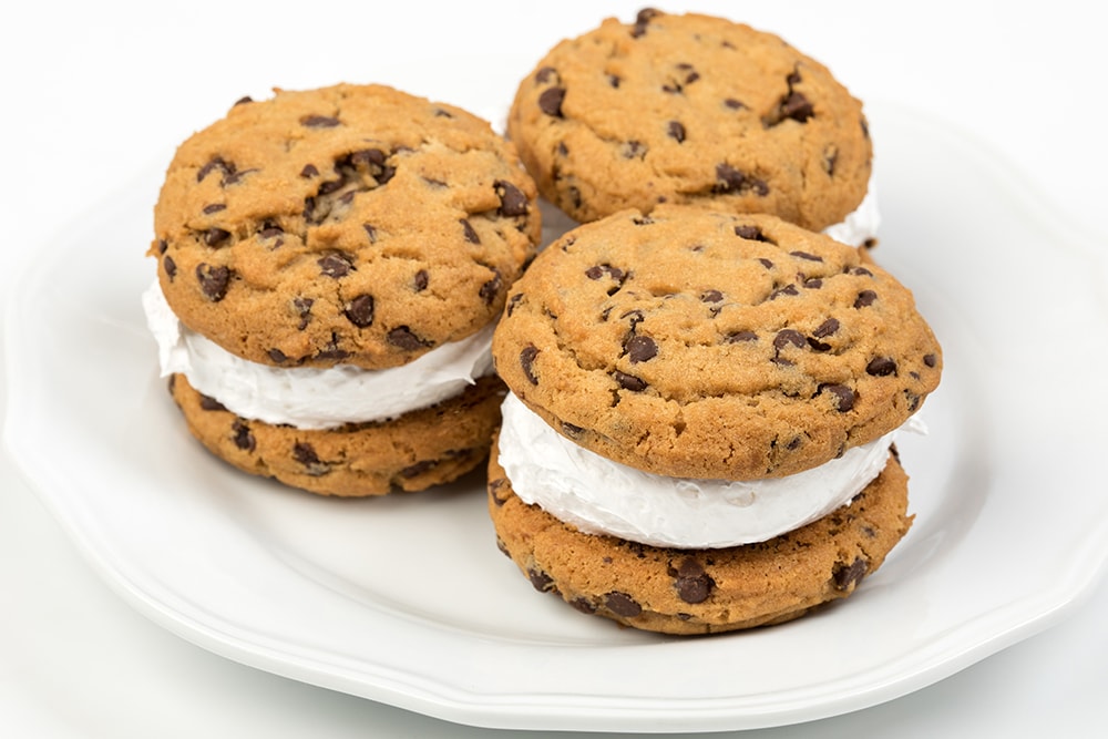 Three handcrafted whoopie pies made with soft chocolate chip cookies and fluffy filling displayed on a white plate, ideal for Kitchen & Food, Snacks and Sweets, USA Made, and Best Sellers collections.