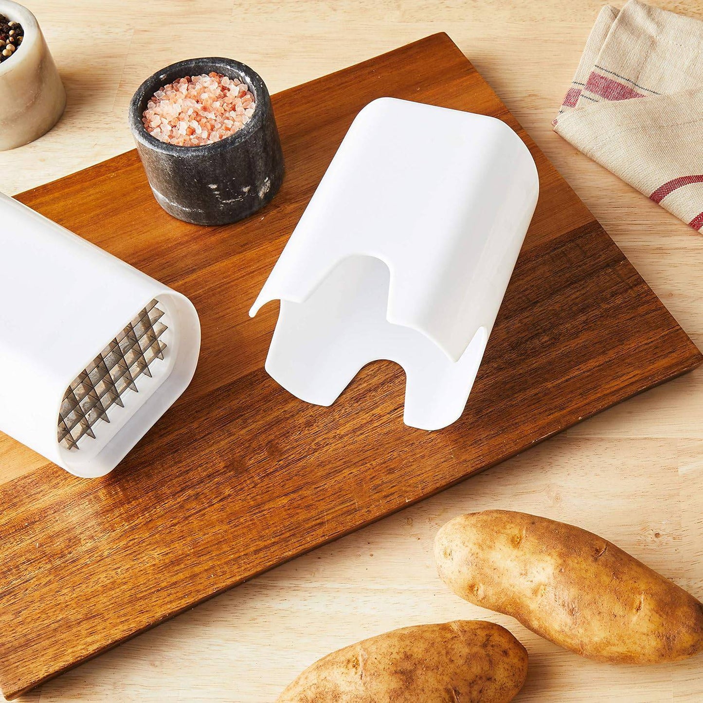 White plastic cutter attachment with sharp stainless steel blades for slicing potatoes and vegetables, displayed on a wooden board with potatoes and seasoning, ideal for Kitchen & Food, Food Prep, Choppers and Cutters, Kitchen Gadgets, Cooking and Baking Helpers, Best Sellers, and Promo Eligible collections.