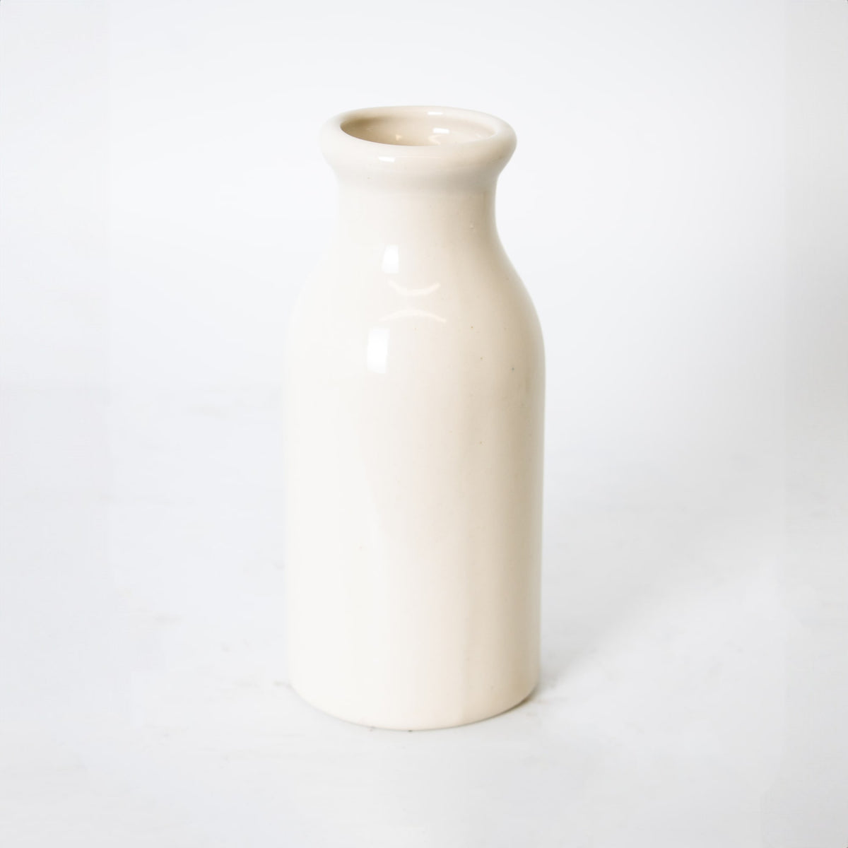 Handmade cream-colored stoneware milk bottle crafted in the USA, perfect for farmhouse-style kitchen decor, storage, and serving in Home & Decor collections.