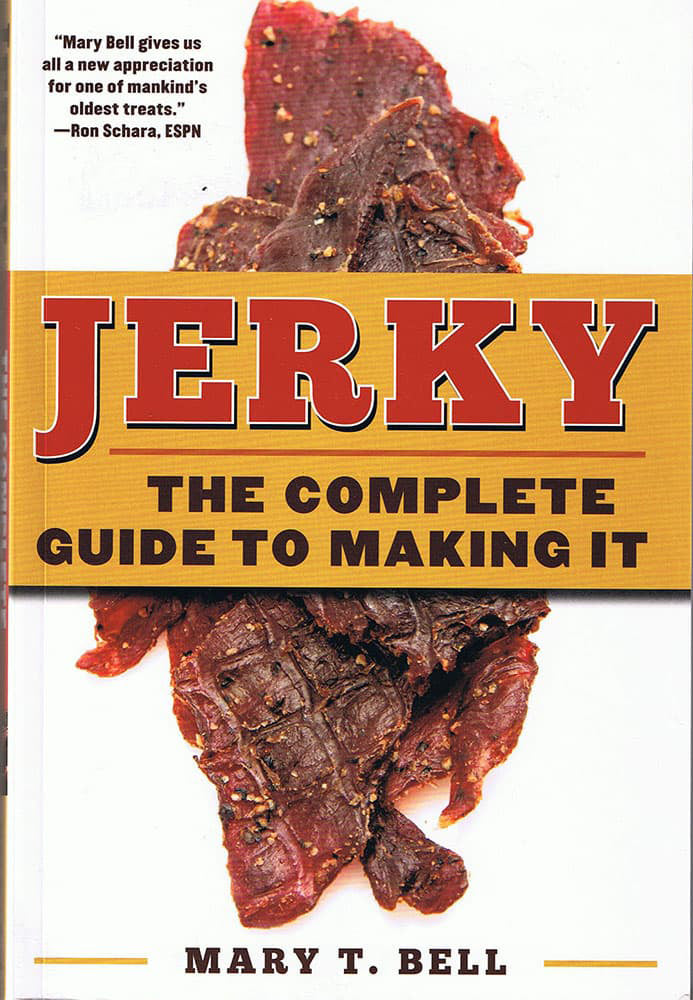 Cover of a cookbook featuring close-up dried jerky strips with bold text highlighting it as a comprehensive guide to making jerky, perfect for cookbooks and heritage collections.