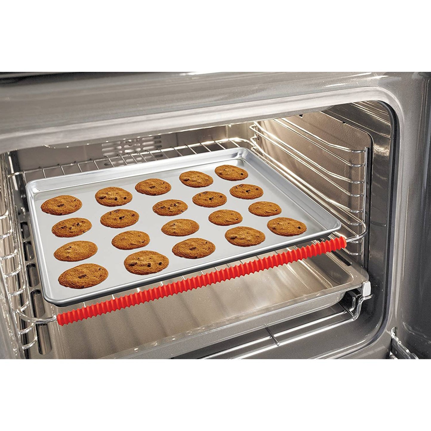 Flexible red silicone oven rack guard installed on the front edge of a metal oven rack with a baking sheet of freshly baked chocolate chip cookies inside, enhancing kitchen safety in Best Sellers and Kitchen Accessories collections.
