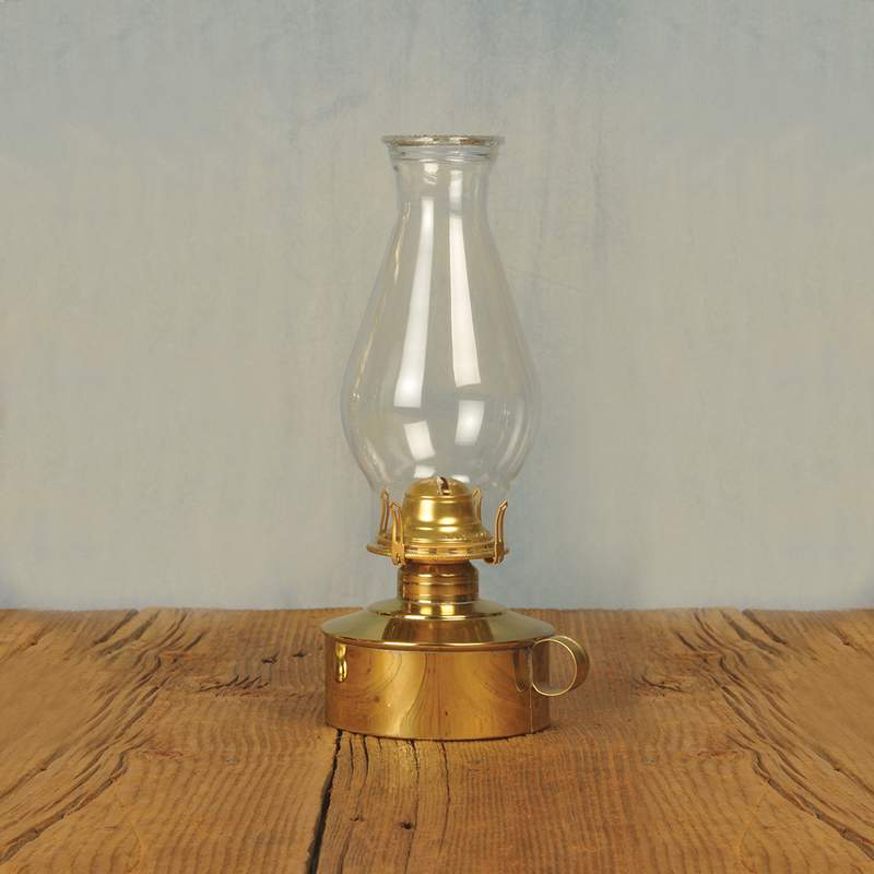 Elegant solid brass table oil lamp with polished finish, classic pearl top glass chimney, finger loop handle, perfect for table or shelf display in lamps and lighting collections.