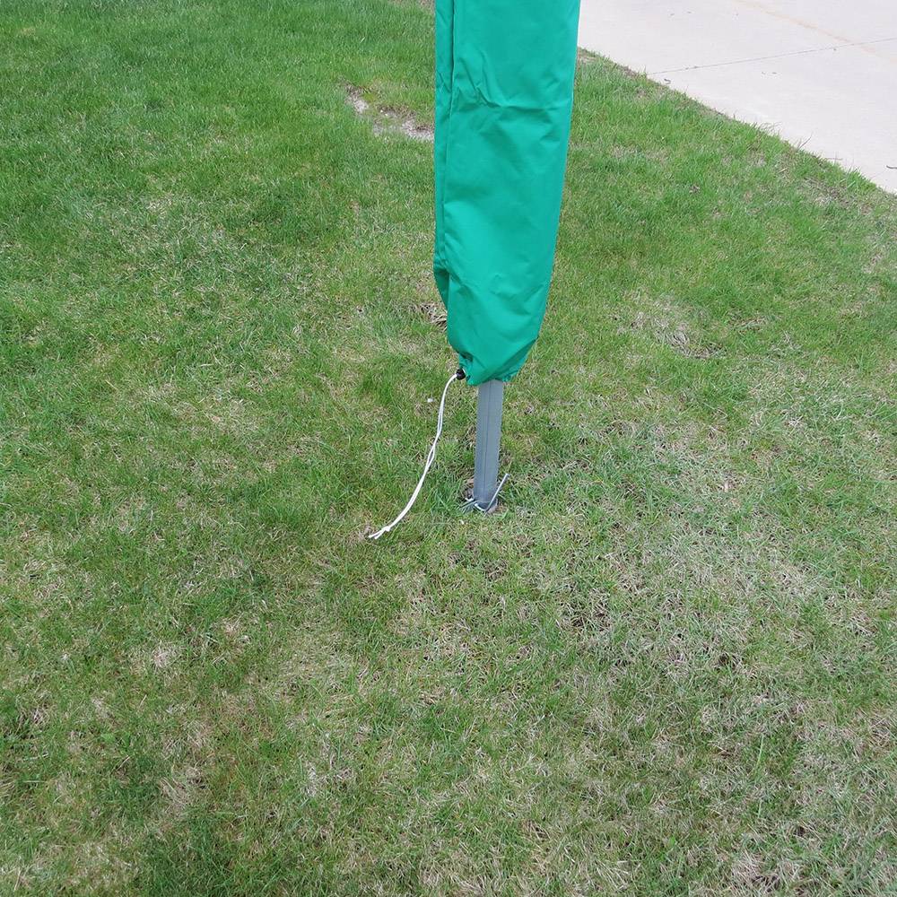 Green weather-resistant protective cover with drawstring closure slipped over clothes dryer pole on lawn, ideal for Home & Decor, Laundry Supplies, and USA Made collections.