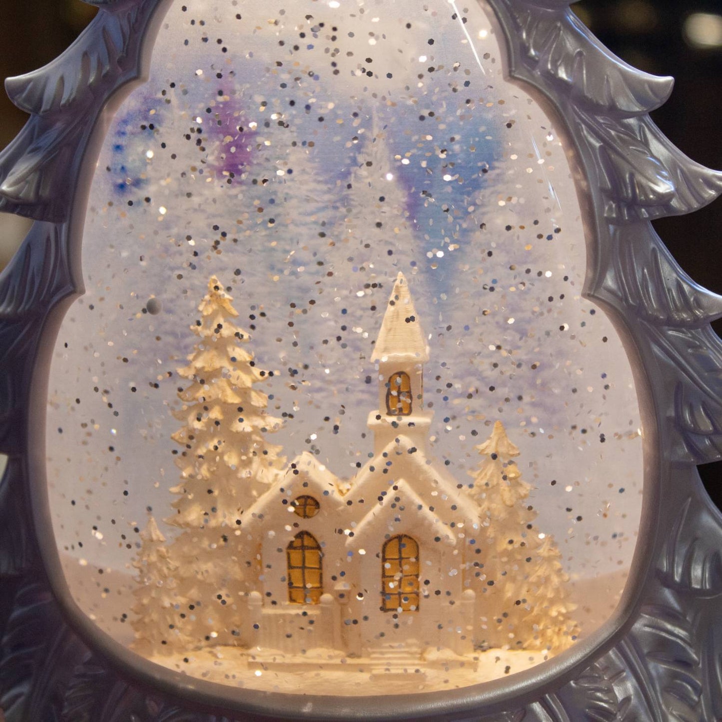 Glowing water globe shaped like a Christmas tree, featuring a snowy church scene with shimmering snow effect and a 6-hour timer, perfect for Home & Decor and Holiday Decor collections.