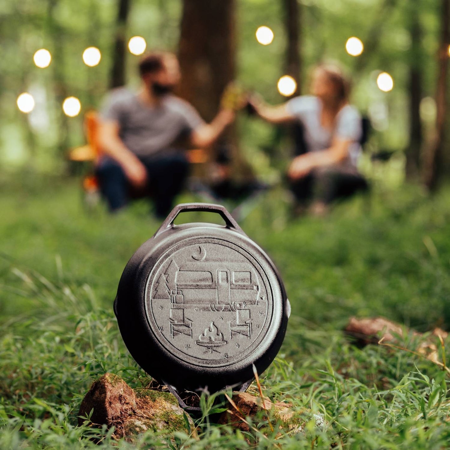 Unique handcrafted cast iron pan featuring a stamped camper and campfire scene, designed for outdoor cooking, camping, and kitchen use, proudly made in USA.