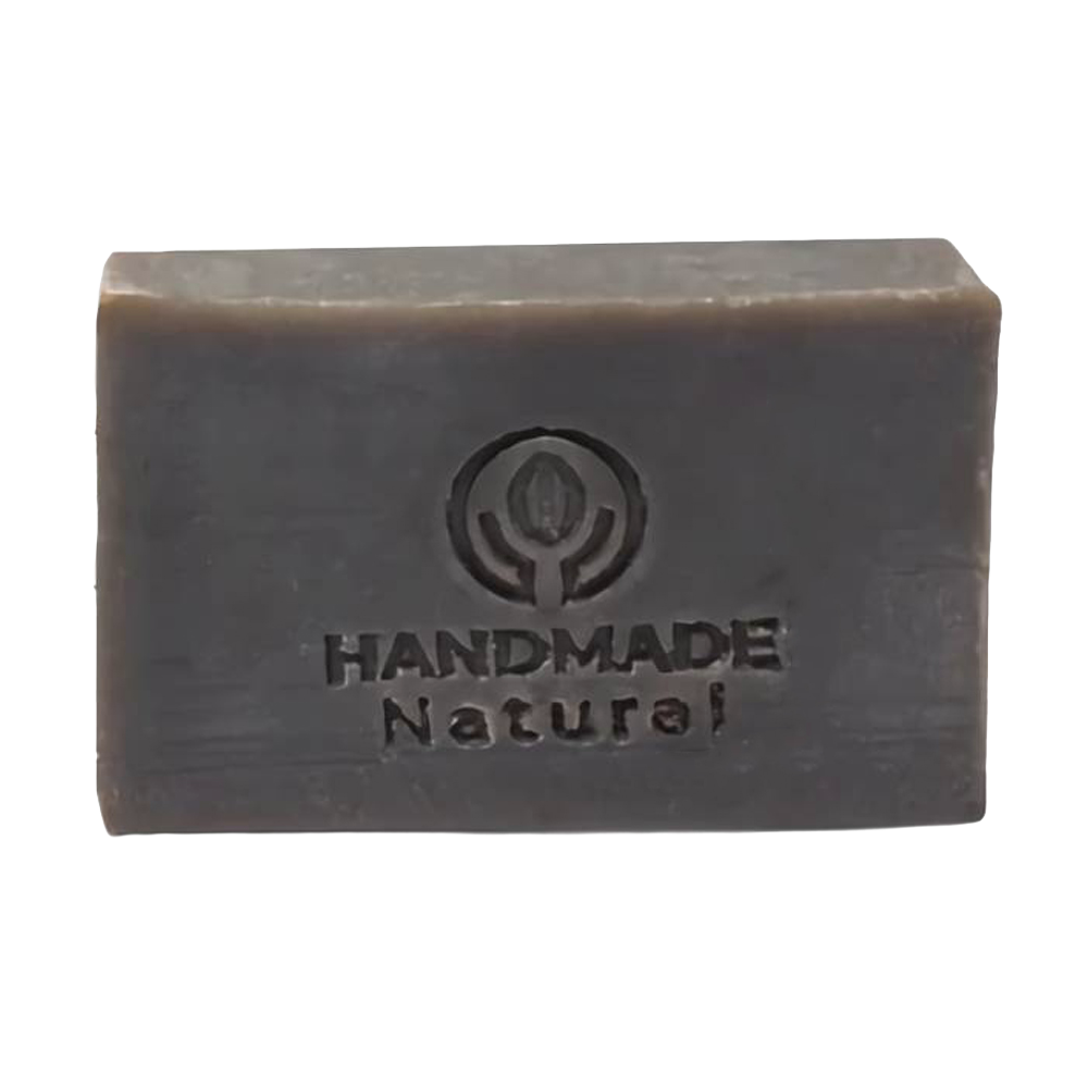 Rectangular dark brown bar of soap embossed with a handmade natural logo, representing an organic, handcrafted Ayurvedic soap ideal for health and wellness collections.