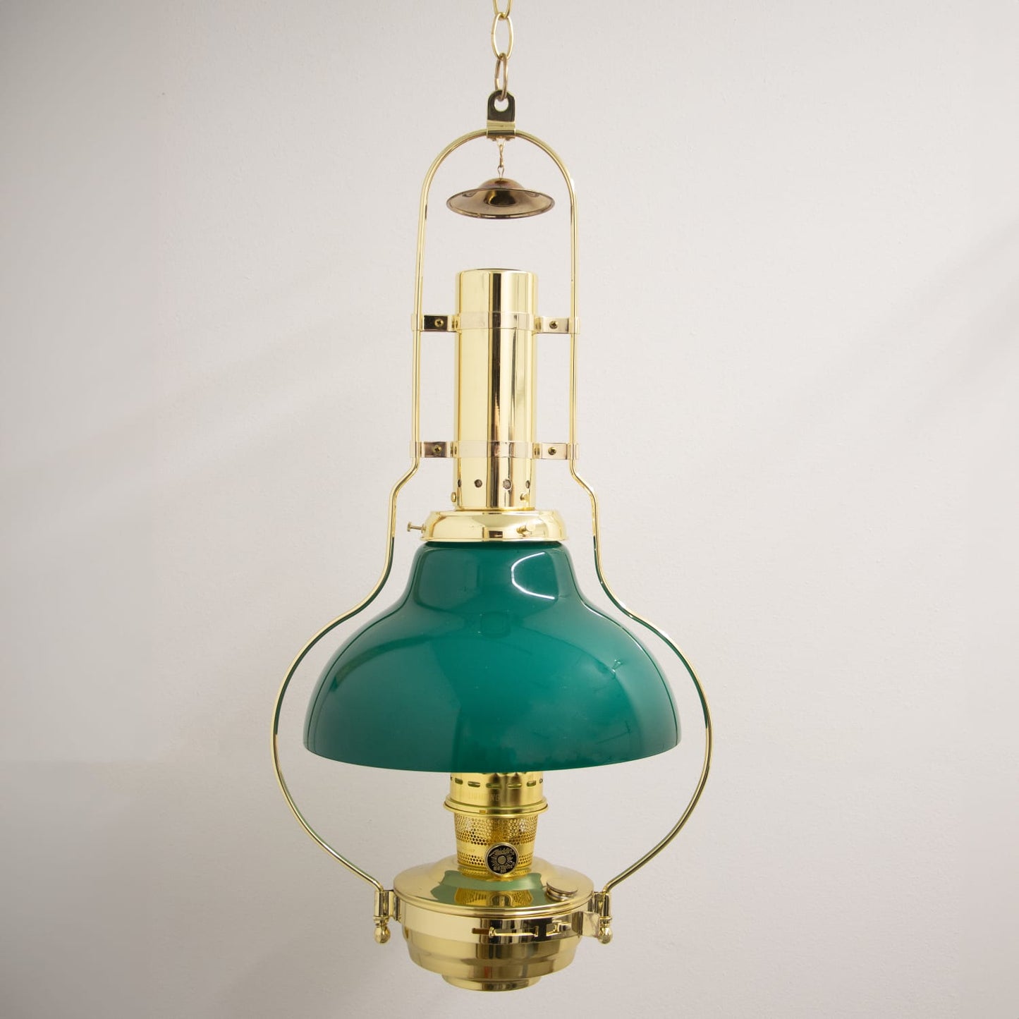 Handcrafted brass hanging oil lamp with a gleaming emerald green glass shade, designed for Farm, Garden & Tool, Lamps & Lighting, Emergency Supplies, and Hanging Lamps collections.