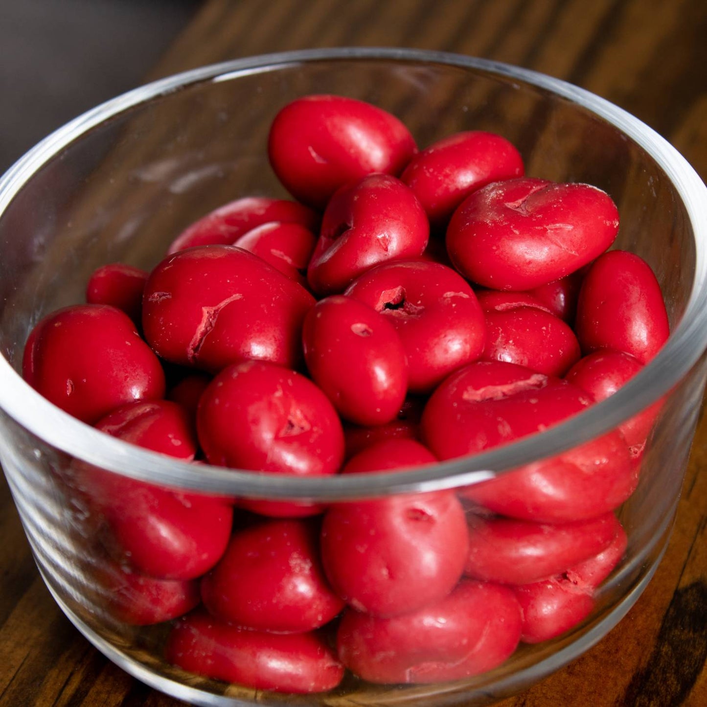 Glass bowl filled with glossy red chocolate covered cherries with a smooth candy coating, handcrafted and made in USA, ideal for Kitchen & Food, Snacks and Sweets, Candy, and Best Sellers collections.
