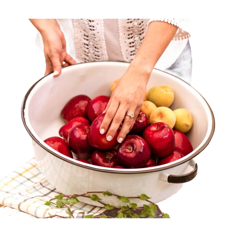 White enamelware basin with black-trimmed handles filled with red and yellow apples, styled for home, garden, camping, and household cleaning use.