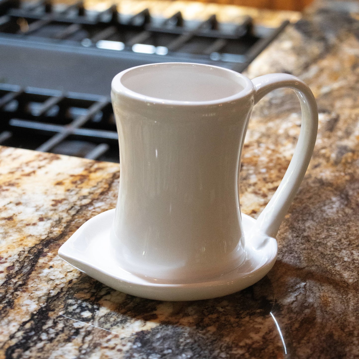 Cream-colored ceramic bacon cooker with a curved handle and grease-catching base, designed for microwave use and easy cleanup, featured in Kitchen & Food and Kitchen Gadgets collections.