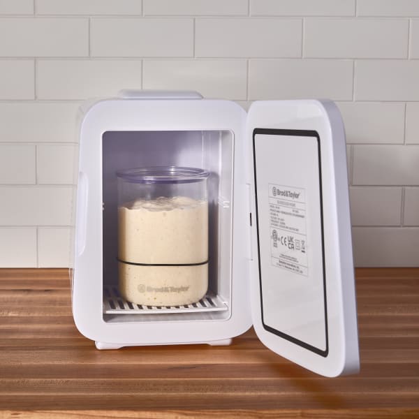 Handcrafted clear borosilicate glass starter jar with black measurement ring inside a white fermentation chamber, ideal for Kitchen & Food, Baking Supplies, and Bread Making collections.