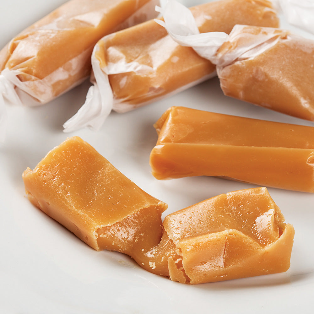 Soft, buttery hand-wrapped caramel candies with a smooth texture, showcasing a classic old-fashioned style, perfect for Kitchen & Food, Snacks and Sweets, and USA Made collections.