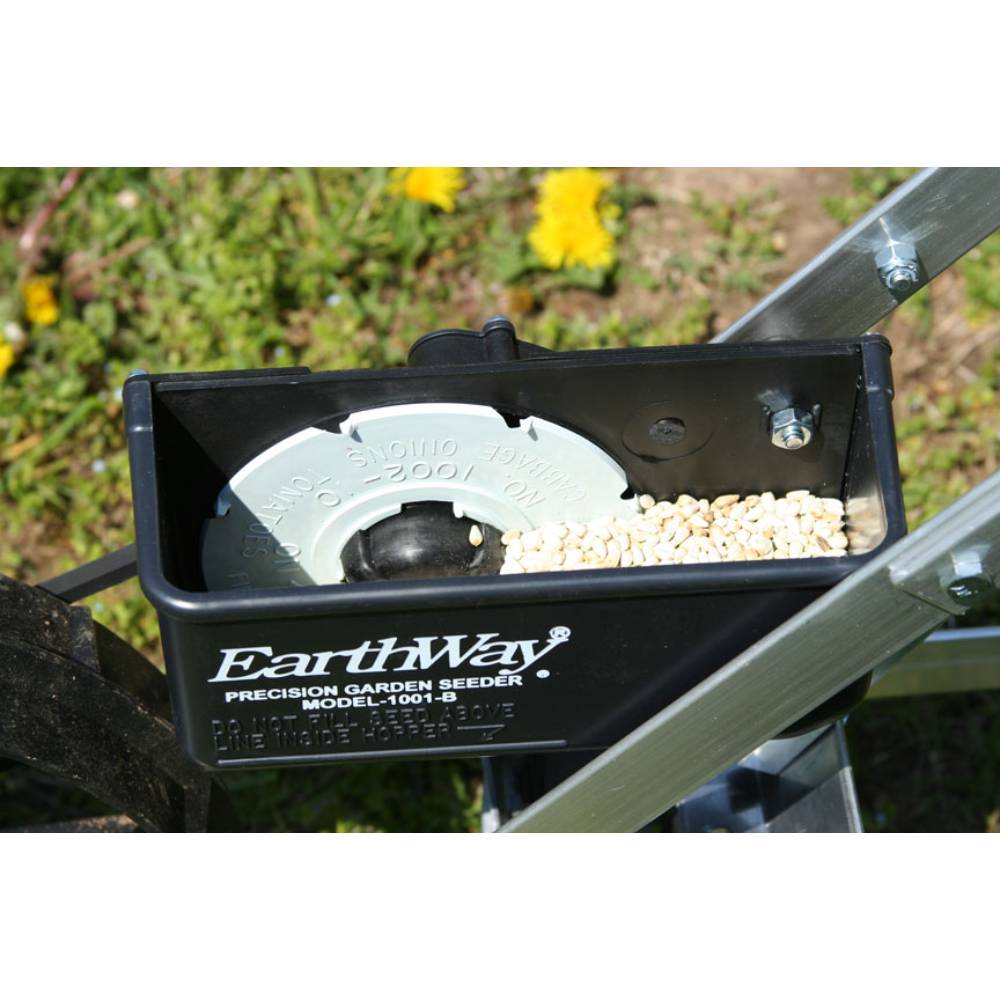 Close-up view of a handcrafted garden seeder hopper filled with seeds, featuring a precision adjustment dial and sturdy metal frame, ideal for Farm, Garden & Tool, Seeds and Planting, USA Made, Best Sellers, and Promo Eligible collections.