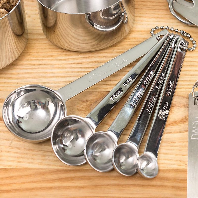 Set of five linked stainless steel measuring spoons with clearly engraved measurements, designed for durable and precise food preparation; featured in Kitchen & Food, Food Prep, Measuring, Best Sellers, and Promo Eligible collections.