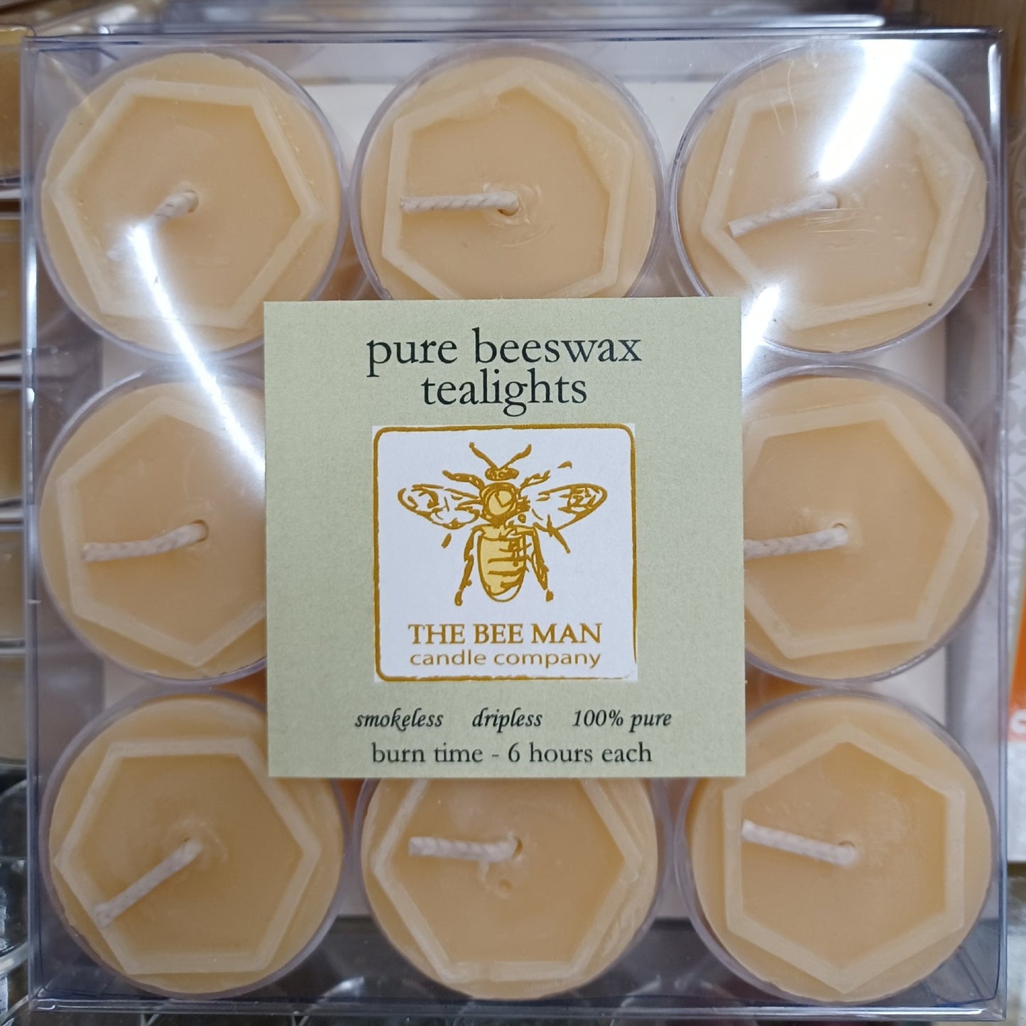 Box of nine handcrafted pure beeswax tealight candles with natural honey color, smokeless and dripless for up to six hours burn time, featured in USA Made and Candles collections.