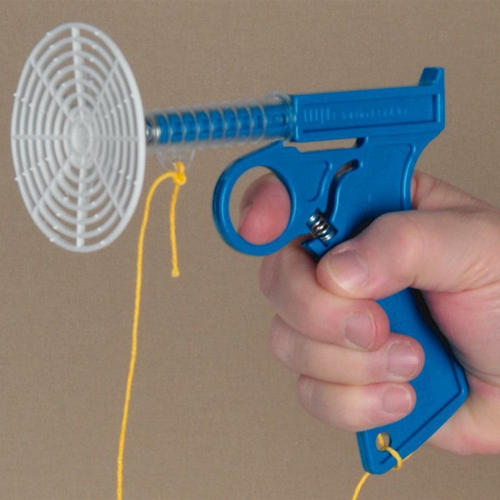 Handcrafted blue plastic spring-loaded fly shooter held in hand with white circular swatter, designed for effective fly control, ideal for Farm, Garden & Tool, Garden Accessories, USA Made, Best Sellers, and Promo Eligible collections.