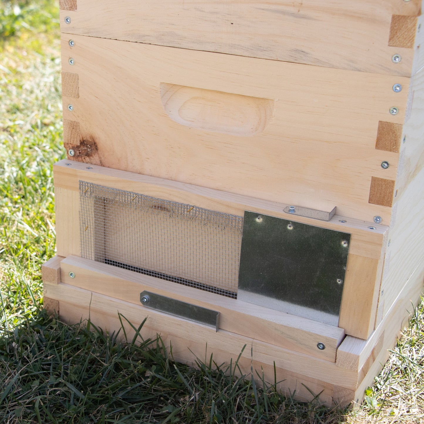 Handmade Amish-crafted wooden bee hive entrance with metal mesh and adjustable metal latch to control bee access, protecting colonies in Farm, Garden & Tool and Beekeeping Supplies collections.