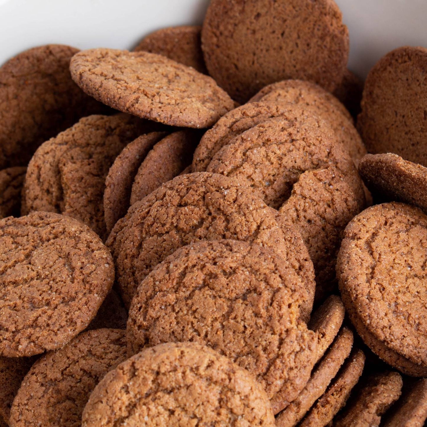 Close-up of handcrafted crispy ginger snap cookies with a textured surface, showcasing warm spices and molasses flavor, featured in Kitchen & Food, Snacks and Sweets, USA Made, and Best Sellers collections.