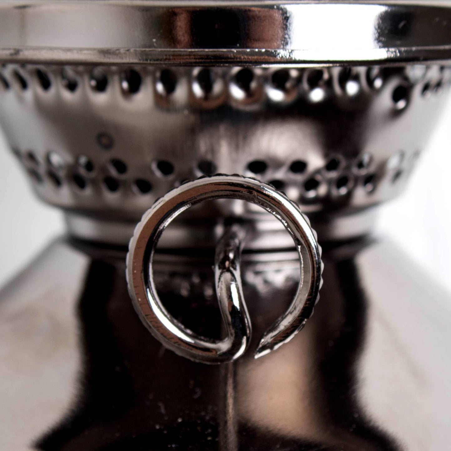 Close-up of a polished metal burner with circular wick holder and ventilation holes, handcrafted for use in wall-mounted oil lamps from Lamps & Lighting and Oil Lamps collections.