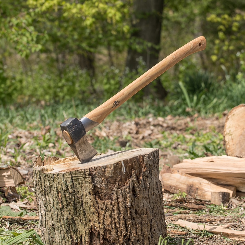 Hand-forged splitting axe with a sharp steel head and smooth wooden handle stuck into a tree stump, handcrafted for durability in Farm, Garden & Tool, Knives & Axes, and Best Sellers collections.