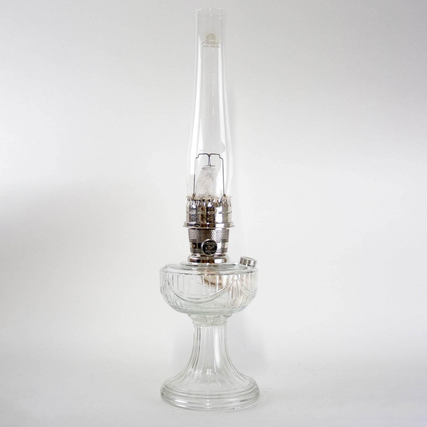 Handcrafted clear glass oil lamp with a unique Lincoln Drape pattern base and polished metal burner, made in USA, featured in Lamps & Lighting, Oil Lamps, Table Lamps, Best Sellers, Promo Eligible collections.