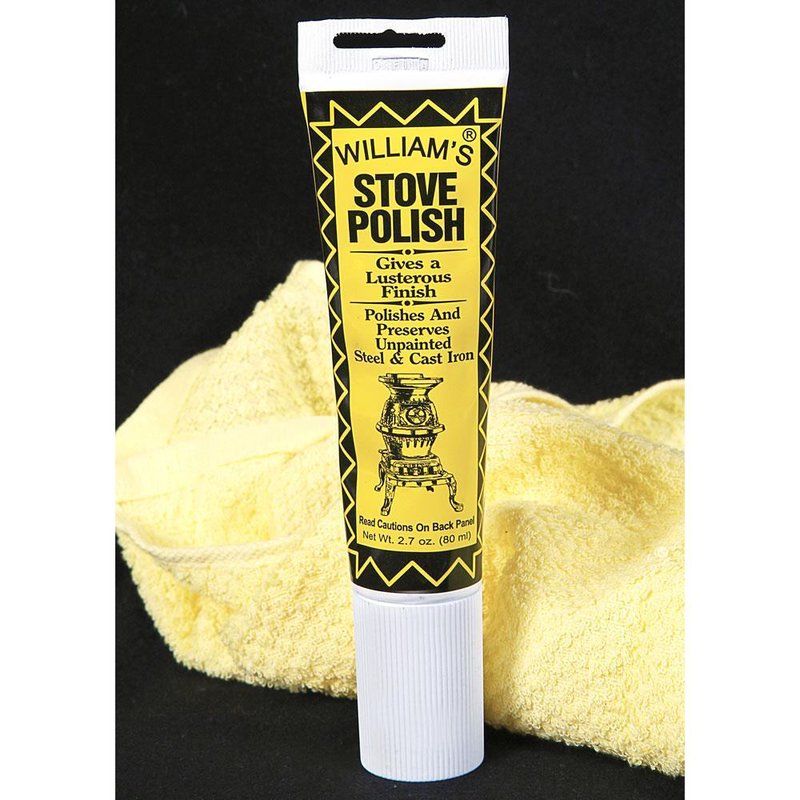 Tube of black satin semi-paste stove polish designed to polish and preserve unpainted steel and cast iron, displayed with a soft yellow cleaning cloth in home and decor setting.