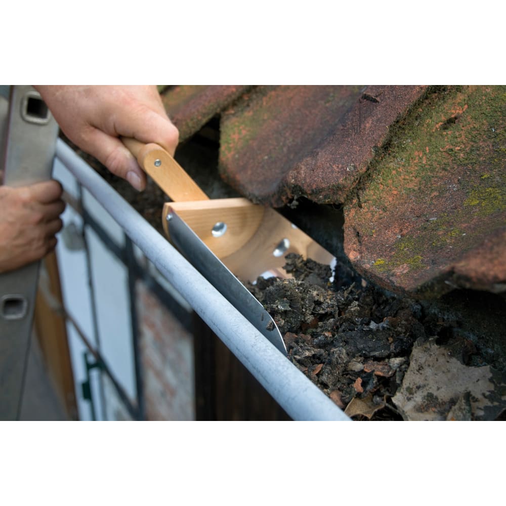 Rotating-handle gutter shovel with a stainless steel scoop and oiled beechwood grip, shown clearing leaves and debris from a mossy roof gutter, part of Farm, Garden & Tool collections.