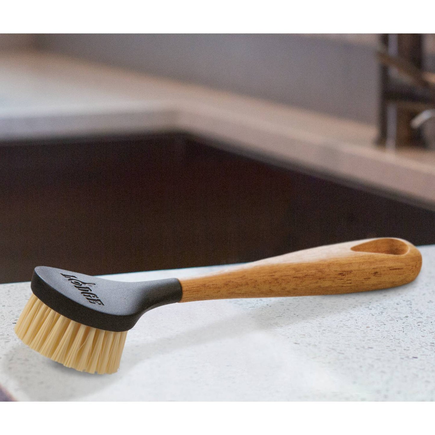 Scrubbing brush featuring stiff nylon bristles and an ergonomic rubberwood handle with a natural lacquer finish, designed for cleaning cast iron cookware, ideal for Kitchen & Food, Cookware, Cast Iron, Best Sellers, and Promo Eligible collections.