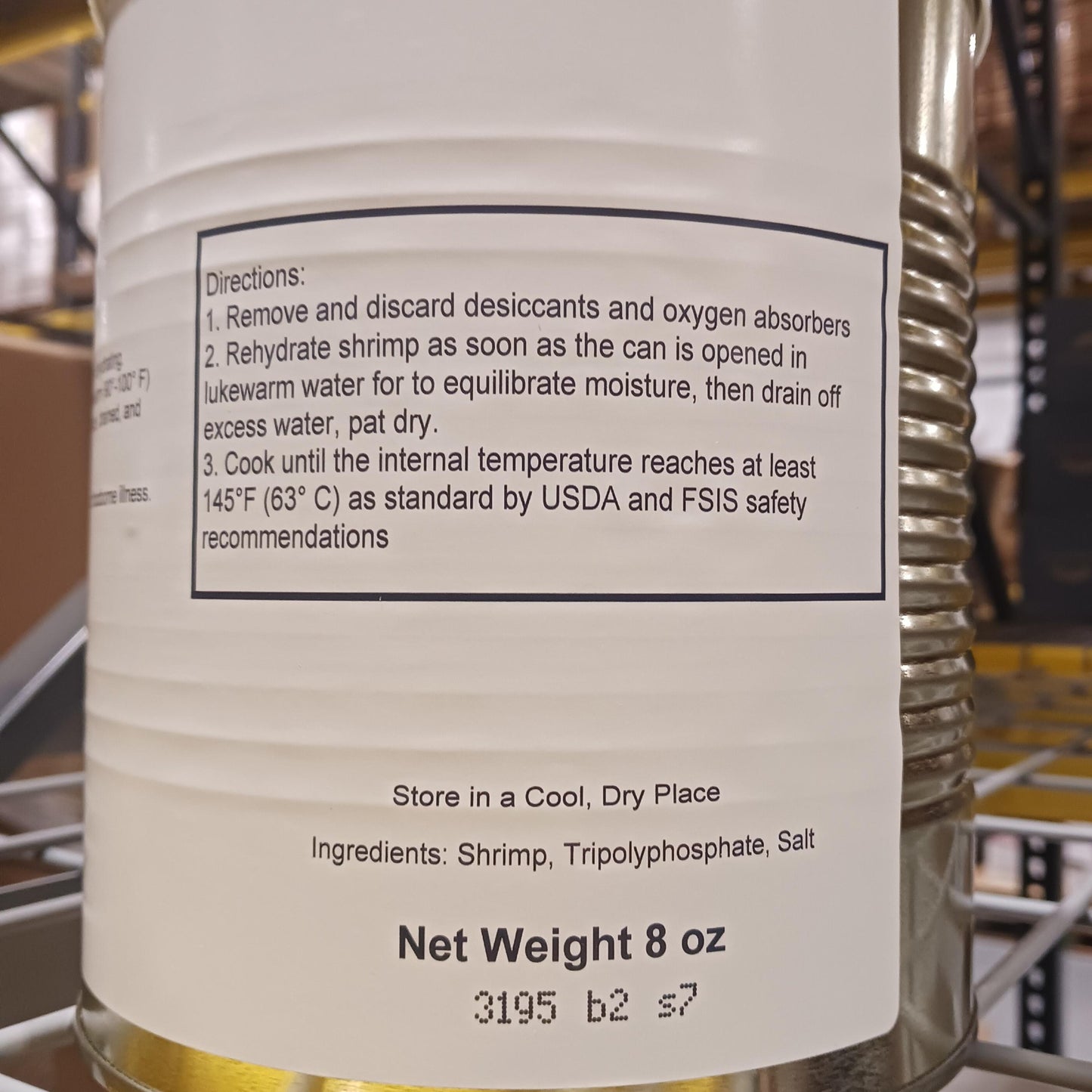 Close-up of a food container label detailing directions for preparing freeze-dried shrimp, including rehydration steps, cooking temperature, and ingredient list, suitable for emergency supplies and long-term food storage.