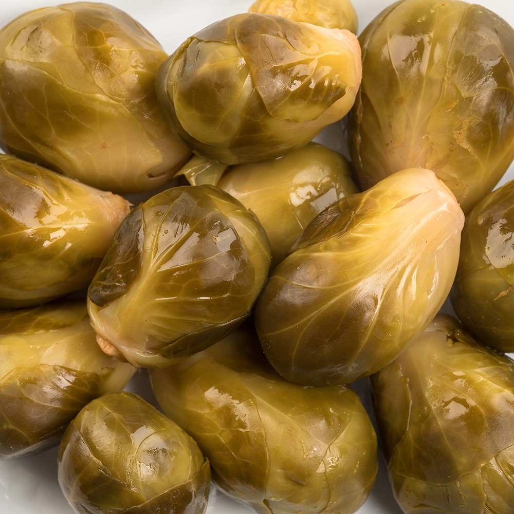 Close-up of glossy, handcrafted pickled Brussels sprouts with a tangy flavor, made in USA, ideal for Kitchen & Food, Food, Pantry, USA Made, Best Sellers, and Promo Eligible collections.