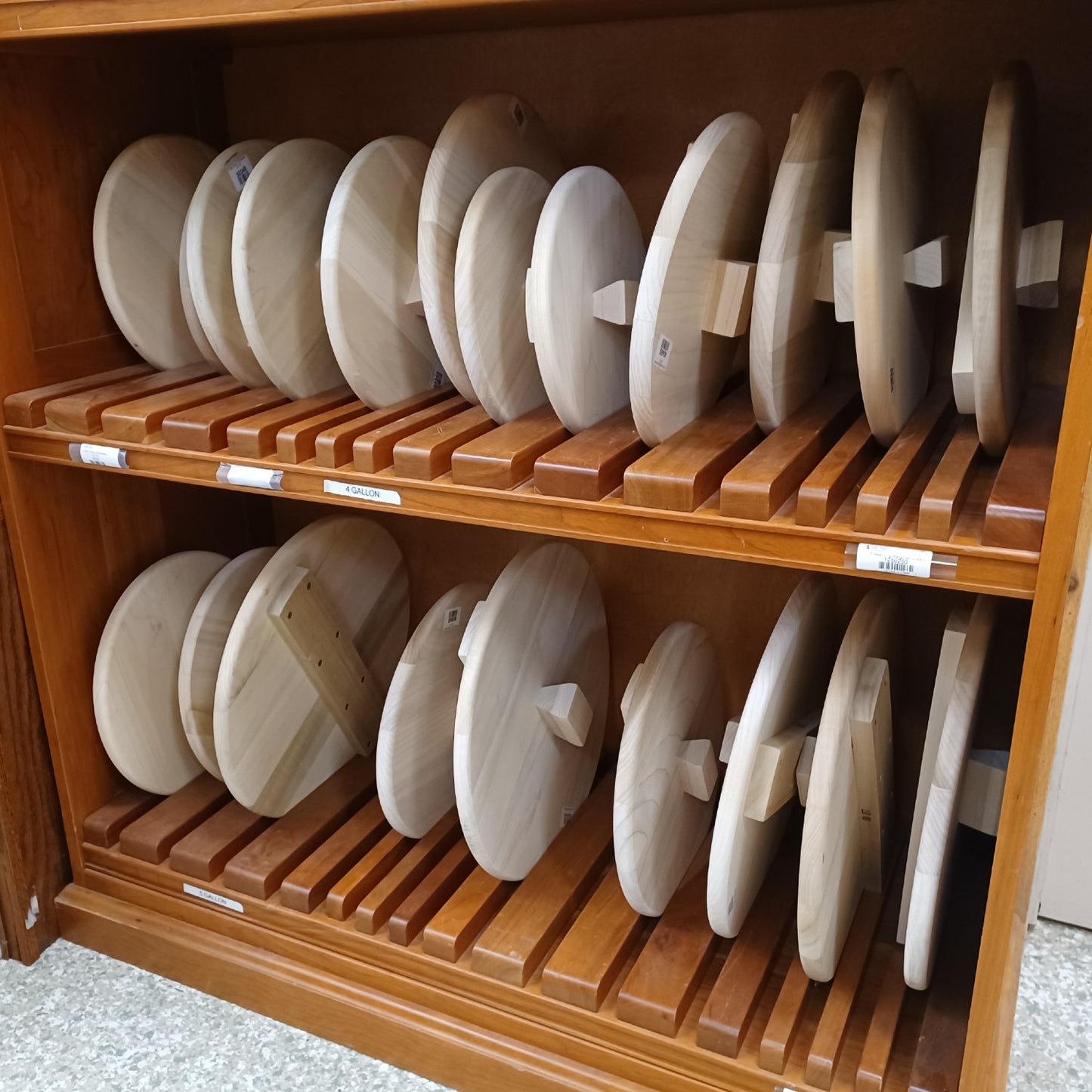 Locally handcrafted unfinished poplar wooden lids with sturdy support bars and handle knobs, arranged on wooden shelves, ideal for Kitchen & Food, Food Preservation, Fermenting and Pickling, USA Made, Best Sellers, and Promo Eligible collections.