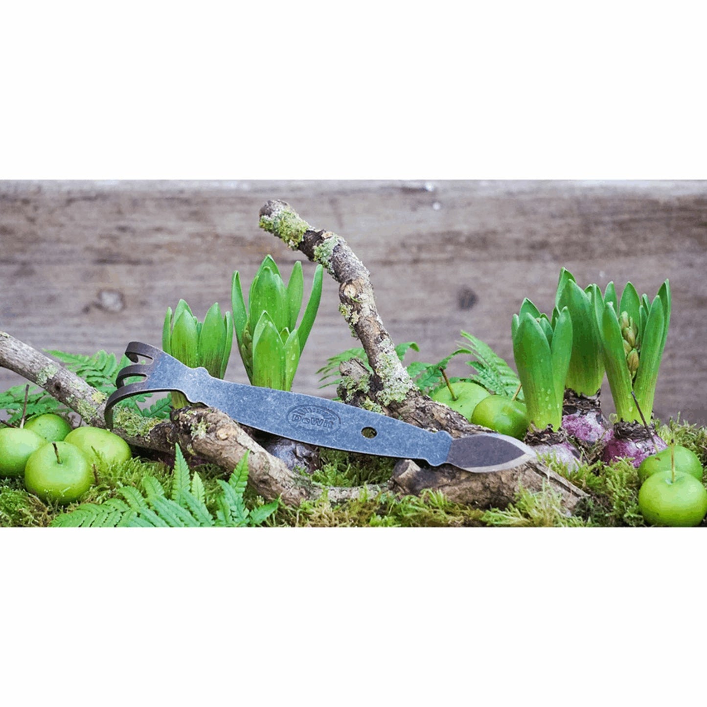 Handcrafted strong steel gardening tool with a three-prong cultivator and cobra-shaped blade resting on natural moss and green sprouts, ideal for Farm, Garden & Tool, Digging and Cultivating, Garden Accessories, Best Sellers, and Promo Eligible collections.