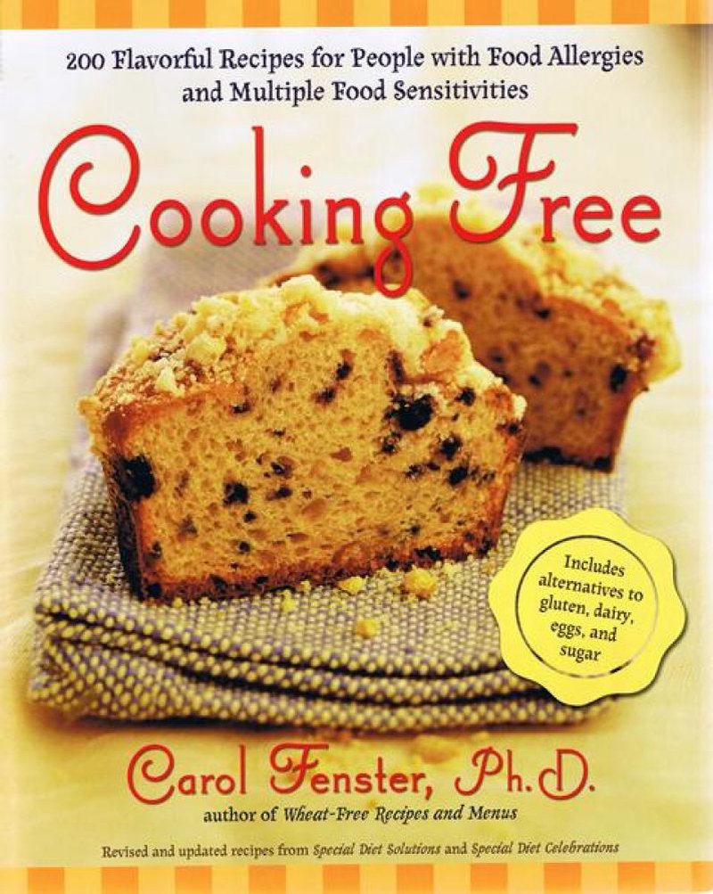 Cover of a cookbook featuring two slices of nut and chocolate chip loaf on a cloth, highlighting recipes for food allergies and sensitivities in Toys, Books & Games, Books, Cookbooks, and Best Sellers collections.