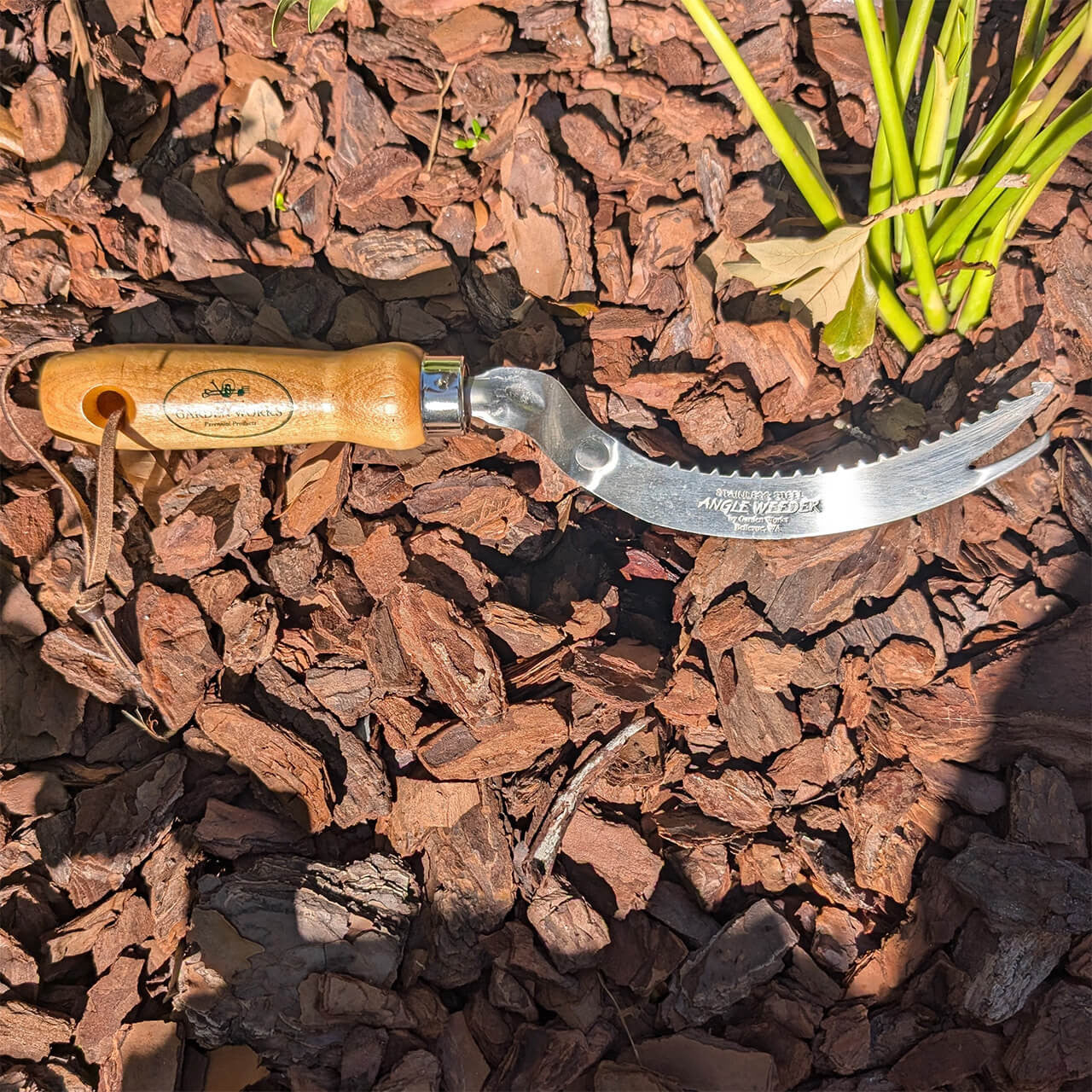 Gardening tool with a curved, serrated metal blade and a smooth wooden handle, designed for precision weeding, featured in Farm, Garden & Tool, Digging and Cultivating, and USA Made collections.